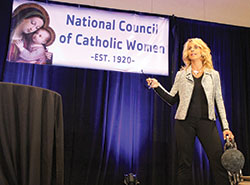 Motivational speaker Judy Hehr uses a ball and chain as a prop to illustrate the feelings of imprisonment that plagued her for decades following childhood abuse and other traumas. Her realization of God’s mercy was her turning point, she told hundreds of participants at the National Council of Catholic Women’s annual convention in Indianapolis on Sept. 9. (Photos by Victoria Arthur)
