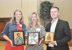 Brie Anne Eichhorn, left, Dr. Casey Reising and Elliott Bedford pose with the awards they received at the Catholic Medical Association reception held at the Archbishop Edward T. O’Meara Catholic Center after the White Mass on Sept. 29. (Photos by Natalie Hoefer)