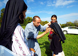 Franciscan of the Immaculate Brother Gabriel Cortes adjusts the veil of Marianne Cloutier, who is playing the part of Jacinta Marto, one of three shepherd children Our Lady of Fatima appeared to in Fatima, Portugal, in 1917. Watching from the left is Maria Siefker, who plays Lúcia dos Santos, and Marianne’s older sister, Maude Cloutier. (Photo by Katie Breidenbach)