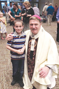 Archbishop Joseph W. Tobin poses on Aug. 13 with Ryan Rutherford after the dedication Mass of the new church of St. Mary Parish in Greensburg. Ryan is a third-grade student at the parish’s school, and recently offered advice to now-Cardinal Tobin as he prepares to leave the Hoosier state to lead the Archdiocese of Newark, N.J. (Submitted photo) 