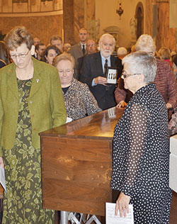 Providence Sister Dawn Tomaszewski, left, walks on Oct. 3, 2014, along a coffin containing the remains of St. Mother Theodore Guérin as it was taken to a new shrine built in her honor on the campus of the motherhouse of the Sisters of Providence of Saint Mary-of-the-Woods. Sister Dawn was elected general superior of the Sisters of Providence on July 3, 2016. Also accompanying the coffin are, from left, Providence Sister Mary Beth Klingel, Tony DuBois, Providence Sister Lisa Stallings (partially obscured) and Providence Sister Denise Wilkinson, general superior at the time. (Photo courtesy of the Sisters of Providence of Saint-Mary-of-the-Woods) 