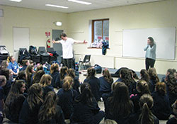 Lindsey Scott, right, and her NET Ministries team members perform a drama during a retreat for 130 seventh-grade girls in Dublin, Ireland, on Jan. 17. Scott, a member of St. Monica Parish in Indianapolis, is a missionary with the nonprofit Catholic ministry, which evangelizes and teaches the faith to youths around the globe. (Submitted photo)