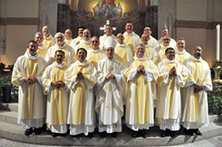 Archbishop-designate Charles C. Thompson poses with 21 newly ordained permanent deacons of the Church in central and southern Indiana on June 24 in SS. Peter and Paul Cathedral in Indianapolis after the Mass in which they were ordained. (Photo by Sean Gallagher)