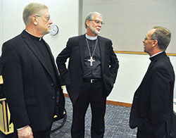 Archbishop Charles C. Thompson, right, speaks with Lutheran Bishop William O. Gafkjen on Sept. 17 at Marian University prior to a lecture that Bishop Gafjken gave on the 500th anniversary of the start of the Protestant Reformation. Bishop Gafkjen is the shepherd of the Indiana-Kentucky Synod of the Evangelical Lutheran Church in America. Father Rick Ginther, left, director of the archdiocesan Office of Ecumenism and pastor of Our Lady of Lourdes Parish in Indianapolis, looks on. (Photo by Sean Gallagher)