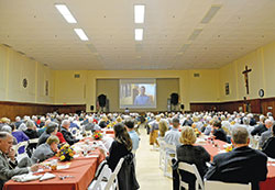 A record 380 people of the Miter Society watch a video about the United Catholic Appeal at the Archbishop Edward T. O’Meara Catholic Center in Indianapolis on Oct. 10.