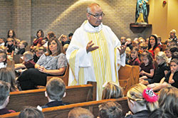 Father Thomas Clegg, pastor of St. John Paul II Parish in Sellersburg, preaches a homily during a Sept. 27 Mass with students of the New Albany Deanery faith community’s school at St. Paul Church in Sellersburg. (Photo by Sean Gallagher)