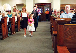 Olivia, left, and Katie Miller, front row, Wyatt McCain, second row, and Renee Tunny, all members of St. John the Baptist Parish in Osgood, bring up offertory gifts during a Sept. 10 Mass at the Batesville Deanery faith community’s church to celebrate the 150th anniversary of its founding. (Submitted photo)