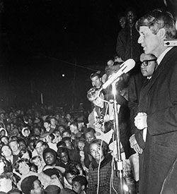 Robert F. Kennedy, right, gives a speech on April 4, 1968, in a park at 17th Street and Broadway Ave. in Indianapolis on the day of the assassination of Rev. Martin Luther King Jr. The speech has been credited with the fact that Indianapolis remained calm in the wake of King’s death. (Indianapolis Recorder Collection, Indiana Historical Society)
