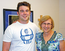 The smiles shared by Bishop Chatard High School senior Kevin McNelis and math teacher Ruth Roell reflect the connections she has made with students in her 43 years of teaching at the archdiocesan high school for the Indianapolis North Deanery. (Photo by John Shaughnessy)
