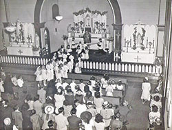 In this undated photo, children of St. Rose of Lima Parish in Franklin receive their first Communion in the parish’s second church. (Submitted photo)