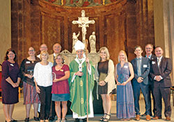 Archbishop Charles C. Thompson is pictured in SS. Peter and Paul Cathedral in Indianapolis on Sept. 18 with archdiocesan staff and the winners of awards that were presented in the areas of Catholic education, catechesis, youth ministry and young adult ministry. Pictured, back row, left: archdiocesan superintendent of schools Gina Fleming; education honoree Lynne Locke; SS. Peter and Paul Cathedral rector Father Patrick Beidelman, who also serves as executive director of the Secretariat for Worship and Evangelization; archdiocesan director of catechesis Ken Ogorek; and director of the Secretariat of Pastoral Ministries Deacon Michael Braun. Front row, left: catechesis honorees Mary Jo Thomas-Day and Connie Powers; Archbishop Thompson; youth ministry honoree Julie Albertson; young adult ministry honoree Susan Grilliot; director of the archdiocese’s Office of Young Adult and College Campus Ministry Matt Faley; and director of the archdiocese’s Office of Youth Ministry Scott Williams. (Photo by John Shaughnessy)