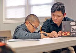 Yan Yan tutors a child as a volunteer for Hope for Tomorrow, an Indianapolis organization that helps Burmese children with their homework. (Submitted photo) 