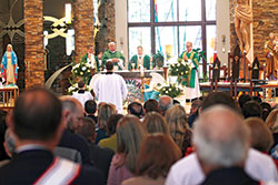 St. Malachy Parish pastor Father Sean Danda, left, Deacon Dan Collier, Archbishop Charles C. Thompson and Deacon Rick Renzi gather around the altar of St. Malachy Church in Brownsburg during a Mass celebrating the parish’s 150th anniversary on Nov. 3. (Submitted photo by David Gansert)