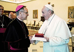 Pope Francis presents Archbishop Charles C. Thompson with a gift on Dec. 12 after the pontiff met in the Apostolic Palace at the Vatican with bishops from Illinois, Indiana and Wisconsin as part of their “ad limina” visit, a pilgrimage to Rome that all bishops from around the world are required to make every five to seven years. (Vatican Media)