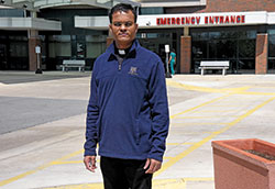 Father Sengole Thomas Gnanaraj, administrator of St. Elizabeth Ann Seton Parish in Richmond, stands outside Reid Health, a hospital in the eastern Indiana city. He is among a select group of priests in the archdiocese who are ministering to the dying during the coronavirus pandemic. (Photo by Sean Gallagher)