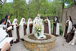 Members of the Discalced Carmelite Monastery of St. Joseph in Terre Haute pray in May around a statue of the Blessed Virgin Mary and the Christ Child on the grounds of their monastery during a May crowning ceremony. The sisters have prayed daily to the Blessed Virgin Mary for an end to the coronavirus pandemic. (Submitted photo)