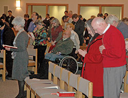 Members of Bloomington Deanery faith communities bow their heads in prayer during a Jan. 31, 2013, liturgy celebrated by then-Archbishop Joseph W. Tobin at St. John the Apostle Church in Bloomington. The parish is celebrating its 50th anniversary in 2020. (Criterion file photo by Mike Krokos)