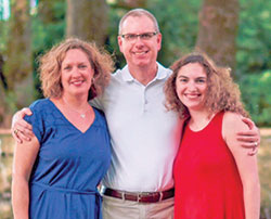 Brian Disney, newly appointed superintendent of Catholic Schools for the archdiocese, is pictured with his wife Tracy and their daughter Kate. (Submitted photo)