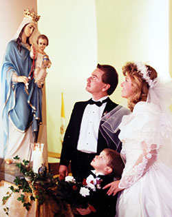 Craig and Linda Whitaker and Linda’s—now the couple’s—son Johnathan honor Mary during their wedding Mass at St. John the Evangelist Parish in Georgetown, Ky., on Dec. 8, 1990. (Submitted photo)