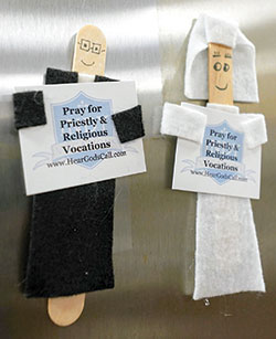 A miniature priest and nun refrigerator magnets are displayed on a refrigerator. In an initiative of the archdiocesan vocations office, 30,000 of them have been crafted and will be distributed in parishes across central and southern Indiana as a reminder to Catholics to pray for priestly and religious vocations. (Submitted photo)