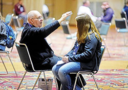 Father John Hall, pastor of St. Anne Parish in New Castle and St. Elizabeth of Hungary Parish in Cambridge City, celebrates the sacrament of penance on Nov. 22, 2019, with a participant in the National Catholic Youth Conference held at the Indiana Convention Center in Indianapolis. (File photo by Sean Gallagher)