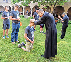 Actress Laura Linney (left) stars wRoman Caito, a member of St. Michael Parish in Greenfield, kneels on June 26 in the courtyard of Bishop Simon Bruté College Seminary in Indianapolis to receive a blessing from newly ordained Father Jack Wright during Bishop Bruté Days, the annual vocations camp of the archdiocesan vocations office. Newly ordained Father José Neri, right, joined Father Wright in offering blessings to lines of camp participants. (Photo by Sean Gallagher)ith the legendary Dame Maggie Smith (right) in the film The Miracle Club, which centers around four women’s trip to Lourdes, France. (Photo courtesy of Sony Pictures)