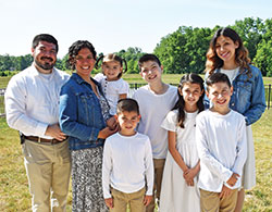 The Cabrera family poses outside of their home in Camby. They are, from left, Daniel, Maria, Fatima Lucia, Joseph, Daniel, Gianna, David and Sara. (Photo by Natalie Hoefer)