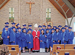 Graduates of the archdiocesan Intercultural Pastoral Institute are pictured with Archbishop Charles C. Thompson after a graduation ceremony in the chapel at Our Lady of Fatima Retreat House in Indianapolis on June 28. In all, 22 individuals received diplomas. (Photo by Mike Krokos)