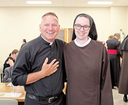 Father Rick Nagel, pastor of St. John the Evangelist Parish in Indianapolis, shares a moment of joy with Franciscan Sister M. Evangeline Rutherford after she professed her perpetual vows on Aug. 2 as a member of the Sisters of St. Francis of Perpetual Adoration, based in Mishawaka, Ind.. Sister Evangeline is a former member of St. John and felt supported by Father Nagel in her path to becoming a religious sister. (Submitted photo)