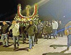 Members of the Hispanic community at St. Michael Parish in Charlestown carry a statue of Our Lady of Guadalupe during a procession on Dec. 11. (Submitted photo)