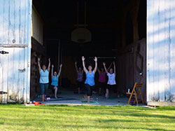 Ruth Beier, center, leads a SoulCore class in a friend’s barn. The workout includes praying the rosary with strengthening, stretching and isometric exercises.