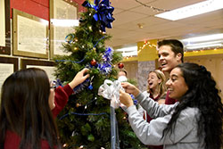 Andrean High School senior student council members decorate a Christmas tree in the senior hall at the Merrillville school on Dec. 7. Andrean students participated in a variety of festive and service-oriented activities in Advent and Christmastime. (Anthony D. Alonzo photo)