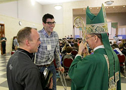 Bishop Charles C. Thompson shares a light moment with Diocese of Evansville seminarians Tyler Tenbarge, left and Garrett Braun before the 2016 Confirmation Spectacular's closing Mass. The Message photo by Tim Lilley.