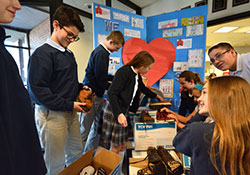 Members of Theresa McLoughlin's seventh-grade homeroom assist in sorting donated shoes at St. Mary Catholic Community School in Crown Point on Feb. 11. The students have participated in a 'Soles for Souls" reuse-and-recycle campaign led by parent Jennifer Walkowiak. (Anthony D. Alonzo photo)