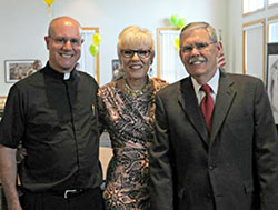 Holy Rosary Pastor Father Bernie Etienne, Bonnie Ambrose, and Charles Voight celebrating at the reception of the Mass of Thanksgiving. Photo by Trisha Hannon Smith.