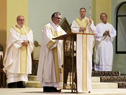 Deacon Thomas Kempf, second from left, reads the Gospel (Matthew 7:6, 12-14) during the June 21 Mass at St. Benedict Cathedral that opened the Diocese of Evansville's observance of the 5th Fortnight for Freedom. The Message photo by Tim Lilley.