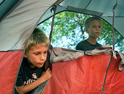 Identical twins William Mazurkiewicz (left) and Joseph Mazurkiewicz, 7, peek into a tent set up outside Holy Spirirt Church for the parish's 'Tent Out' overnight gathering on July 8 in Winfield. Coordinated by Boy Scout troop 88, the educational event recreated aspects the Jewish Feast of Tabernacles. (Anthony D. Alonzo photo)