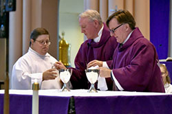 Robert Moravec, a Ss. Peter and Paul parishioner with special needs, presents a cruet filled with water to Deacon Christopher McIntire, as Deacon Duane Dedelow assists at the altar during the annual Other Abled Mass sponsored by The Office of Intercultural Ministries and The Apostolate for the Other Abled, at Holy Angels Cathedral in Gary on March 19. Also pictured in background (left to right) are servers Caitlin Perosky and Chris Neff and Deacon Michael Halas. (Anthony D. Alonzo photo)