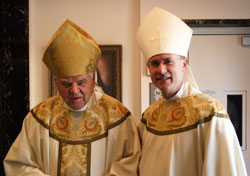 Bishop John M. D’Arcy (left) stands with Bishop Kevin C. Rhoades.