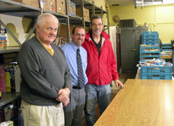Jim Christie, executive director of The Franciscan Center, center, poses with food pantry volunteers John Matera, left, and Dave Sensenich, right, on Nov. 5. The food pantry operates Tuesdays and Thursdays from 9-11 a.m. in the basement of the Sacred Heart School in Fort Wayne at 4643 Gaywood Dr.