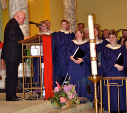 Benedictine Father Gregory Chamberlin offers a blessing to the Diocesan Choir last Sunday at the conclusion of their concert at St. Benedict Cathedral in Evansville where he serves as pastor. The group left Tuesday for a 10-day trip to Italy with scheduled stops in Venice, Florence, Siena, Assisi, Padua, Rome and Vatican City. (Message photo by Mary Ann Hughes)