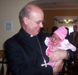 Bishop Kevin C. Rhoades got acquainted with the youngest resident of Hannah’s House on his first visit to the “Maternity Home with a Heart,” on March 18.