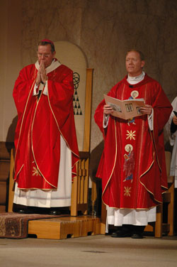 Archbishop Daniel M. Buechlein, left, and Father Patrick Beidelman, rector of SS. Peter and Paul Cathedral in Indianapolis, pray during a Mass on June 29 closing the centennial year of the church. (Photo by Mary Ann Wyand) 