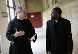 Benedictine Father Denis Robinson, the new president-rector of Saint Meinrad School of Theology, speaks earlier this spring with Kizito Winani, a transitional deacon for the Diocese of Springfield-Cape Girardeau, Mo. Most archdiocesan seminarians receive several years of priestly formation at Saint Meinrad. (Photo courtesy Saint Meinrad Archabbey)