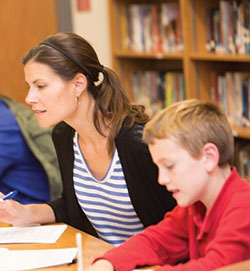 Emily Denton strives to give her students at St. Thomas Aquinas School in Indianapolis “a sense that we’re all on this journey together, and we are here to care for each other.” Here, she works alongside Owen DeLaney. (Submitted photo)