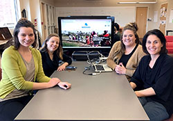 Part of the team responsible for the Blue Roots project show off their Watershed website on March 2. From left, staff member Faith Kellermeyer, students Aiste· Manfredini and Briee Eikenberry, and advisor Dr. Jennifer Palilonis. (Photo by Katie Breidenbach)