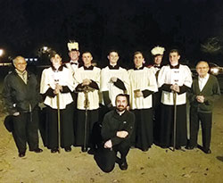 Father Dustin Boehm, pastor of St. Gabriel Parish in Connersville and St. Bridget of Ireland Parish in Liberty, poses with altar servers, members of the parish’s Knights of Columbus and others prior to one of St. Gabriel’s “Novena of Sundays” rosary walk evenings. (Submitted photo)