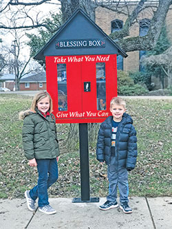 Parishioners of all ages at Most Sacred Heart of Jesus Parish in Jeffersonville are excited to help individuals and families in need through the “Blessing Box” on the parish grounds. Hadly, left, and Hays Nickell pose by the stand-alone structure that is filled with non-perishable food items and toiletries that anyone in need can access at any time of day. (Submitted photo)