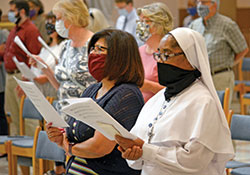 Rose Ruiz, left, and Daughters of Mary Mother of Mercy Sister Loretto Emenogu sing during a Mass for Peace and Justice celebrated on Sept. 9 in SS. Peter and Paul Cathedral in Indianapolis. (Photo by Natalie Hoefer)