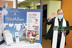 Archbishop Charles C. Thompson blesses Birthline Ministry’s new space in the Xavier Building, 1435 N. Illinois St., on the campus of the Archbishop Edward T. O’Meara Catholic Center in Indianapolis on Oct. 7. (Photo by John Shaughnessy)